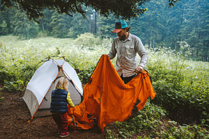 Father and daughter are setting up camping tent family vacations travel lifesty, a Person Photo by e v e r s t