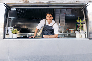 Food truck owner smiling, a Business Photo by Artem Varnitsin