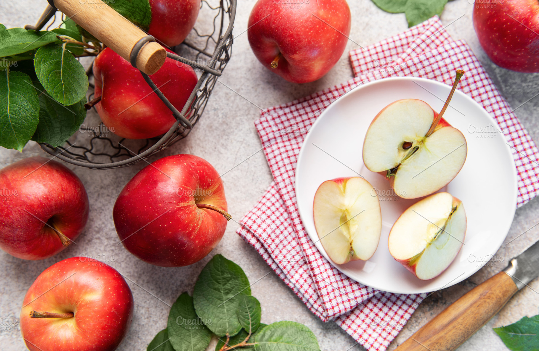 Fresh red apples in basket and sliced on plate, a Food & Drink Photo by Olena Rudo