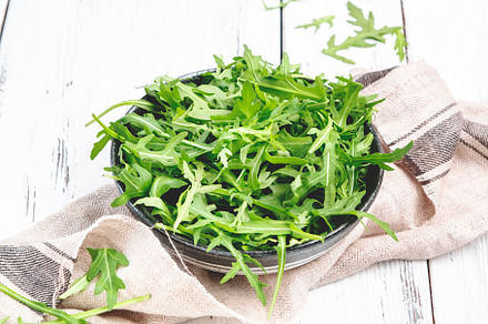 Fresh green arugula in rustic ceramic bowl on white kitchen tabl, a Food & Drink Photo by 5PH