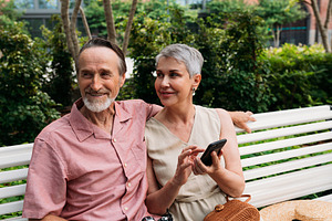 Smiling retired couple sitting, a Person Photo by Artem Varnitsin