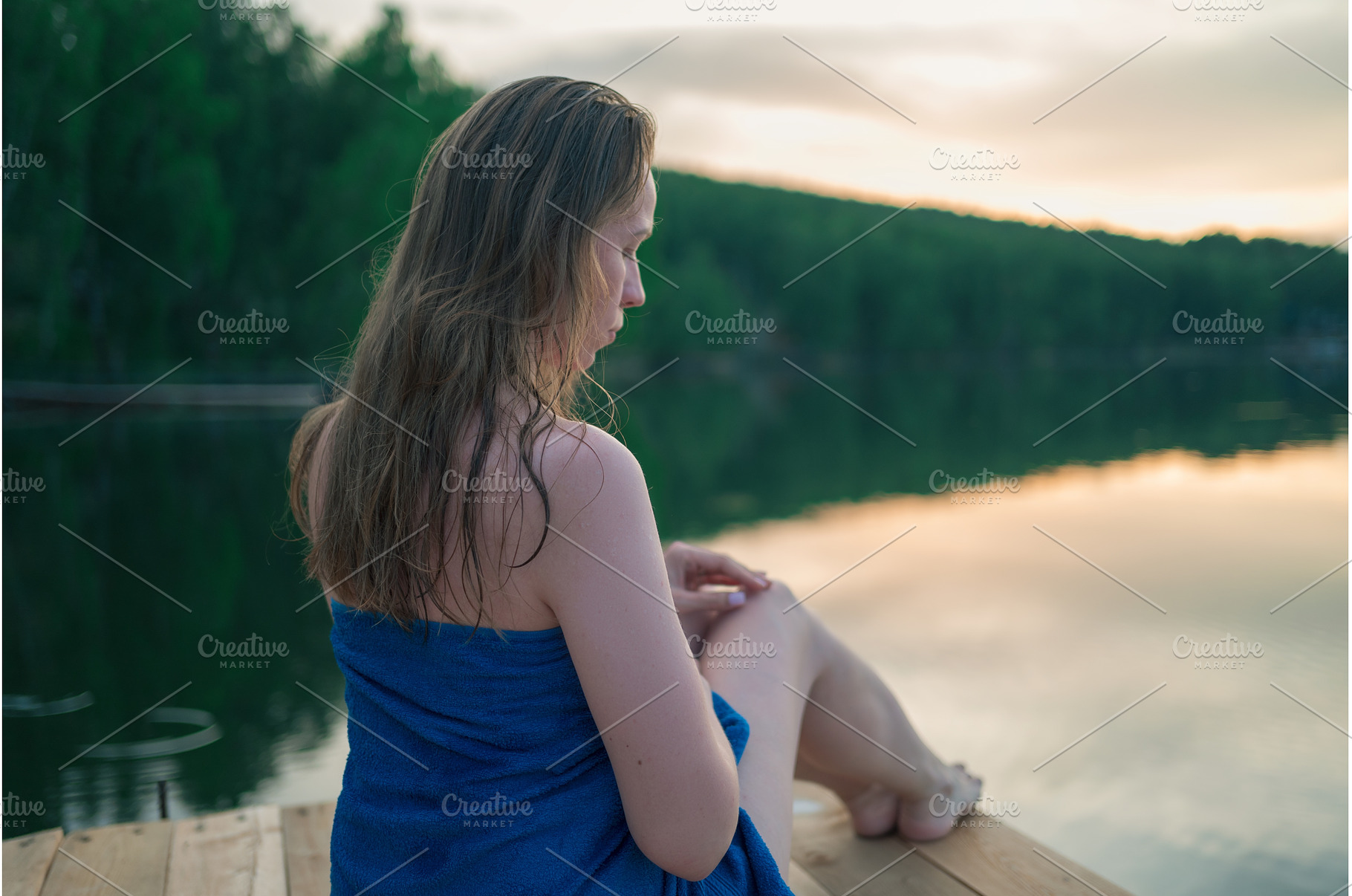 Woman Relaxing by Lake Wrapped in, a Person Photo by Jan Jack Russo Media