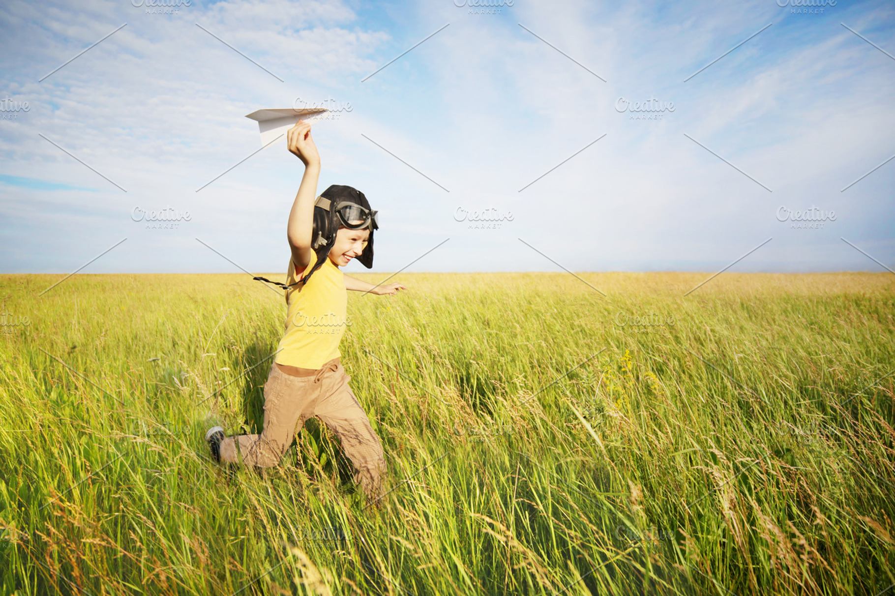 Young pilot containing pilot, child, and paper airplane, a Person Photo by Anton_Sokolov
