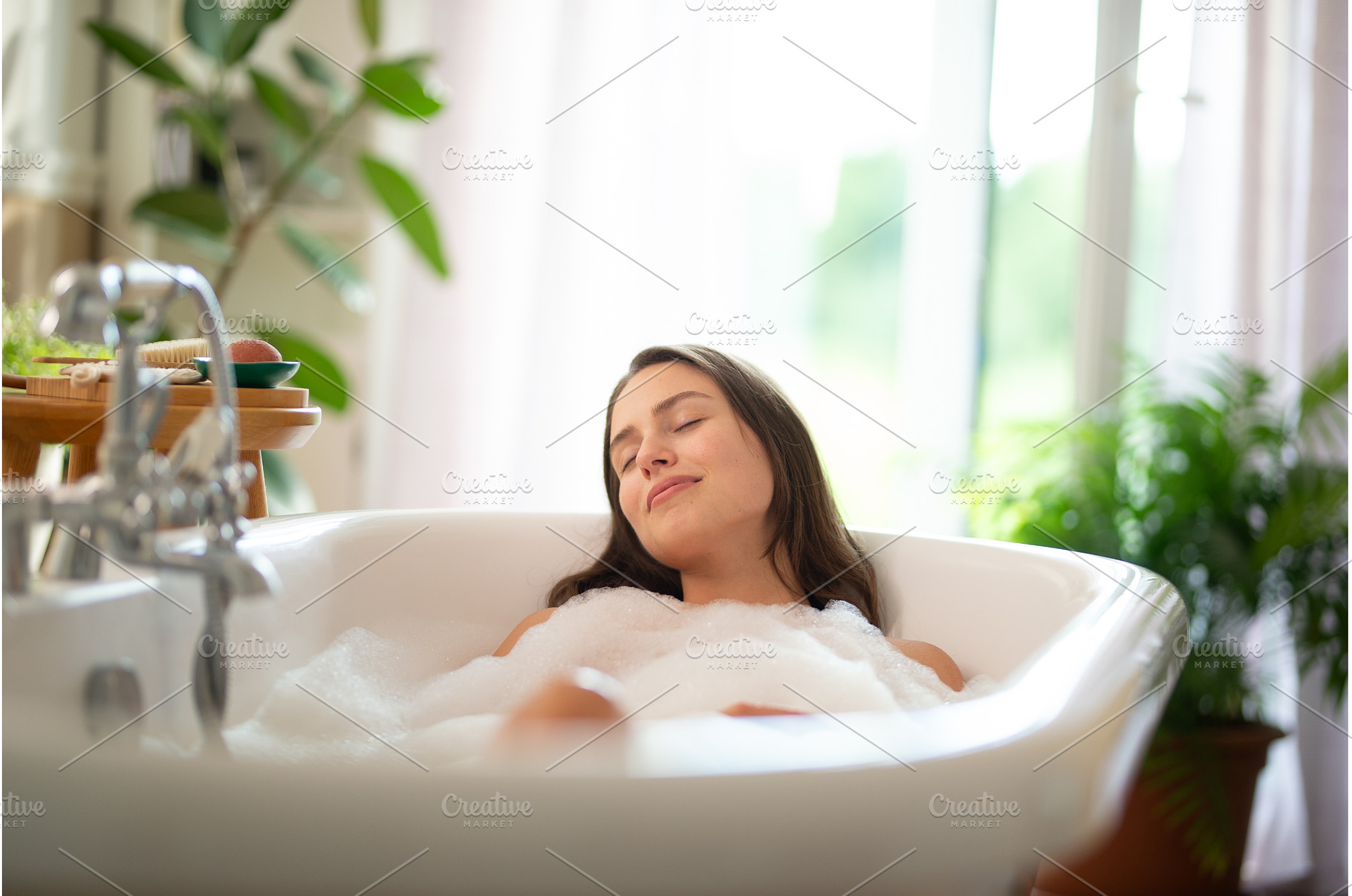 Young woman relaxing in bubble bath, a Beauty & Fashion Photo by HalfPoint