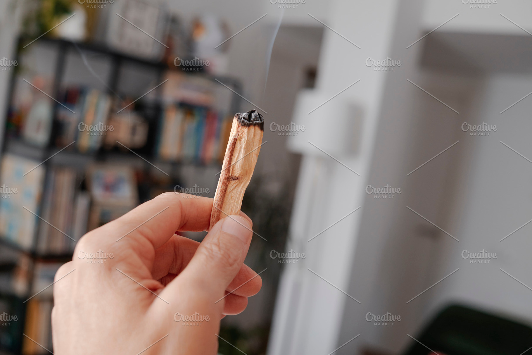 a man scents a room with sandalwood smoke, a Photo by Nito