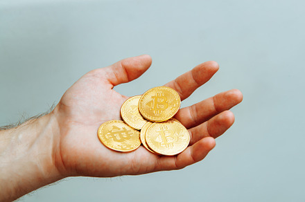 Bitcoins in hand on a light background., a Business Photo by Rov.7