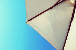 Beach umbrella featuring umbrella, beach, and blue sky