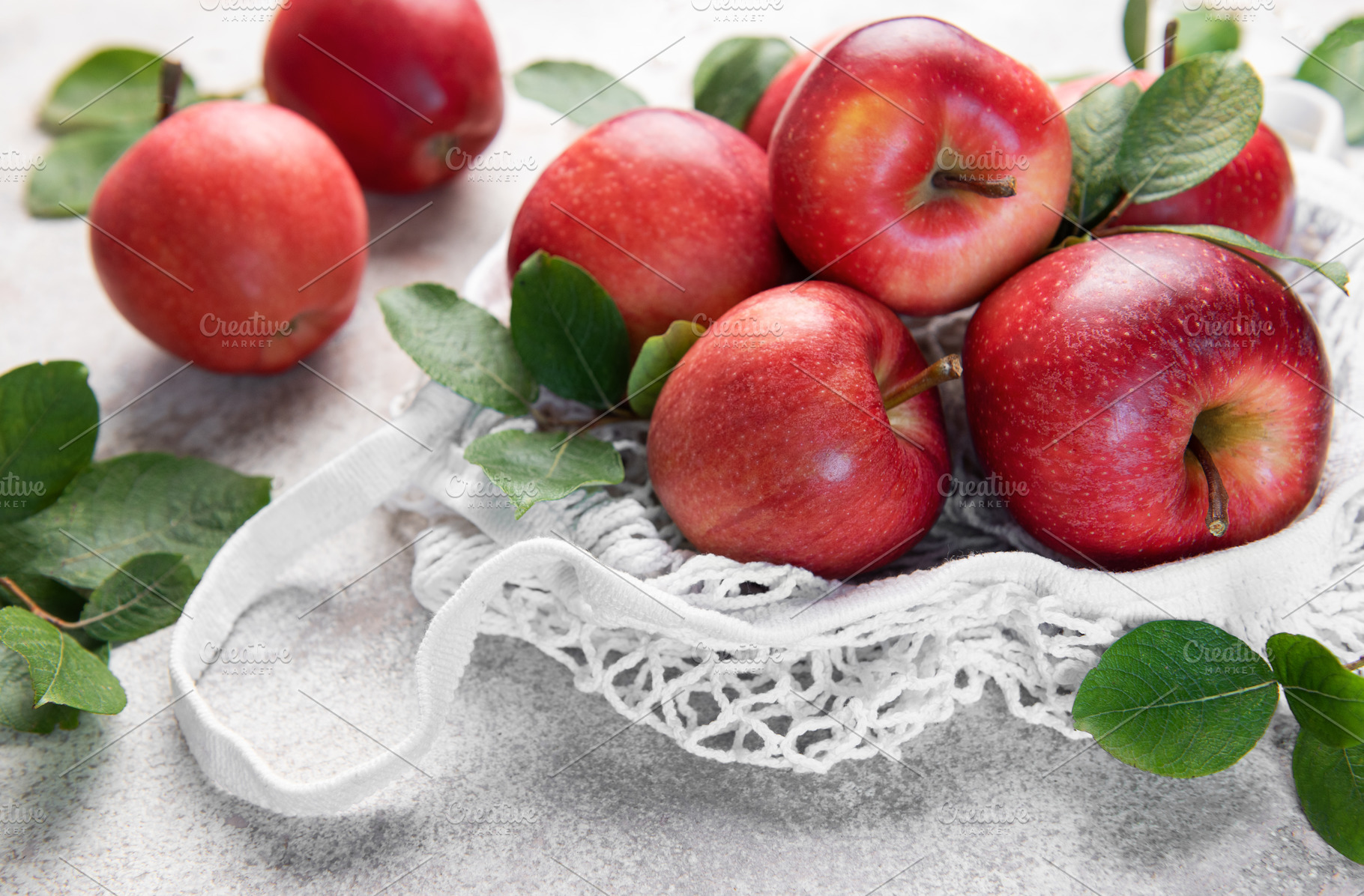 Fresh red apples resting in a reusable shopping bag, a Food & Drink Photo by Olena Rudo