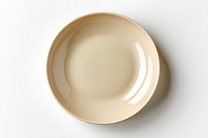 Minimalist flat ceramic plate with smooth surface in neutral tones on white bac, a Food & Drink Photo by AlyaAnd