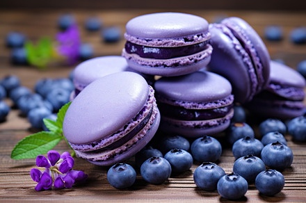 Purple macarons dessert with blueberry on wooden background, a Food & Drink Photo by AlyaAnd