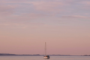 Sailboat At Sunset Stock Photo