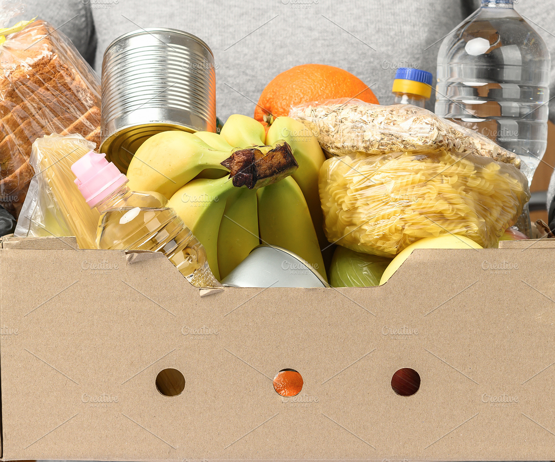 A cardboard box filled with food and water bottles, a Food & Drink Photo by ndanko