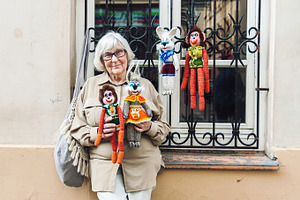 Senior lady selling knitted toys, a Person Photo by BOOCYS
