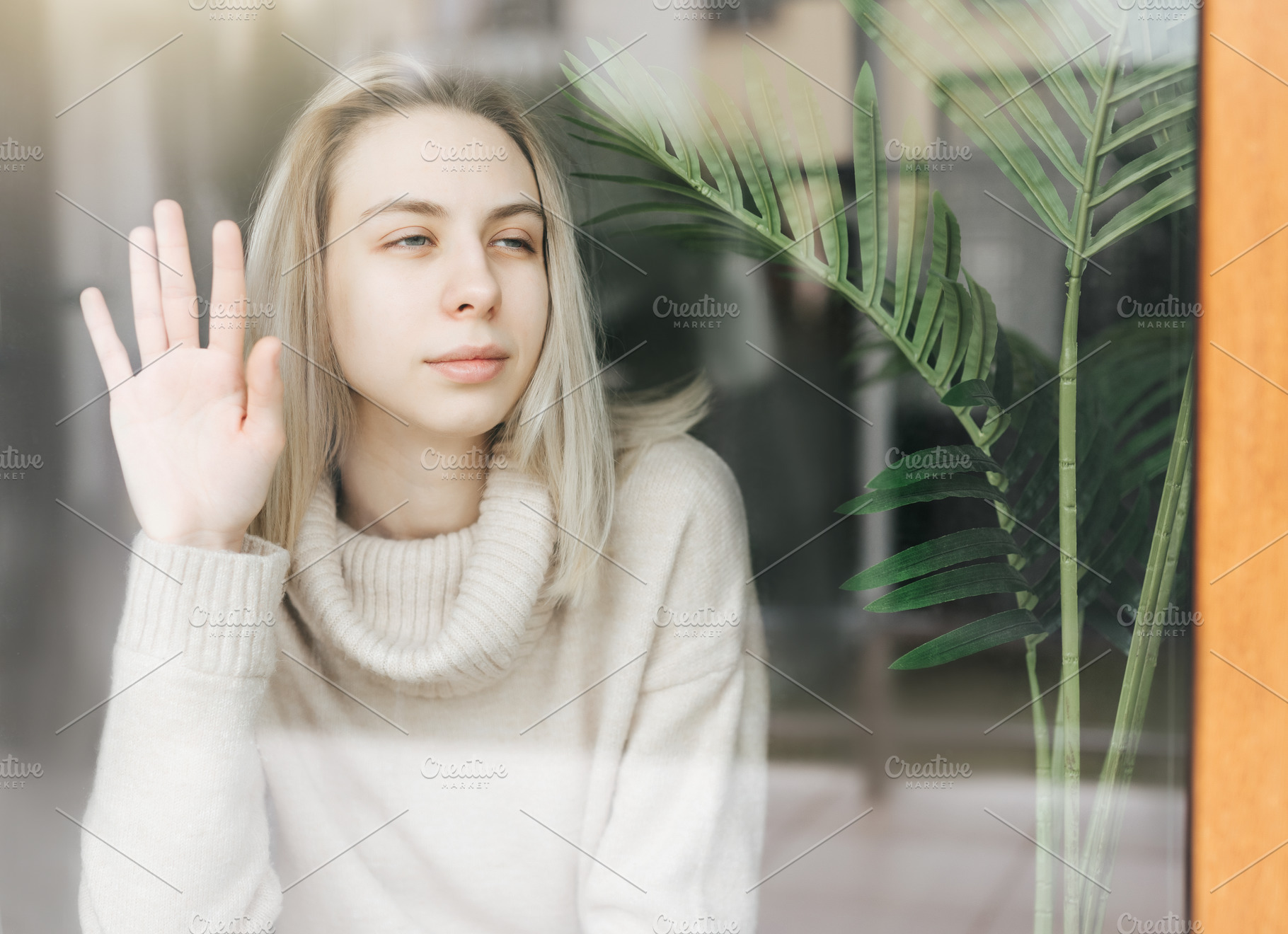 Sad girl near window thinking about something, a Person Photo by Olena Rudo