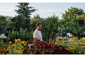 Garden store employee taking care of, a Nature Photo by HalfPoint