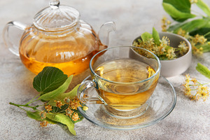 Linden tea brewing in glass teapot with cup, a Food & Drink Photo by Olena Rudo