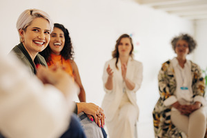 Businesswomen applauding their colleague during a meeting, a Person Photo by Jacob Lund