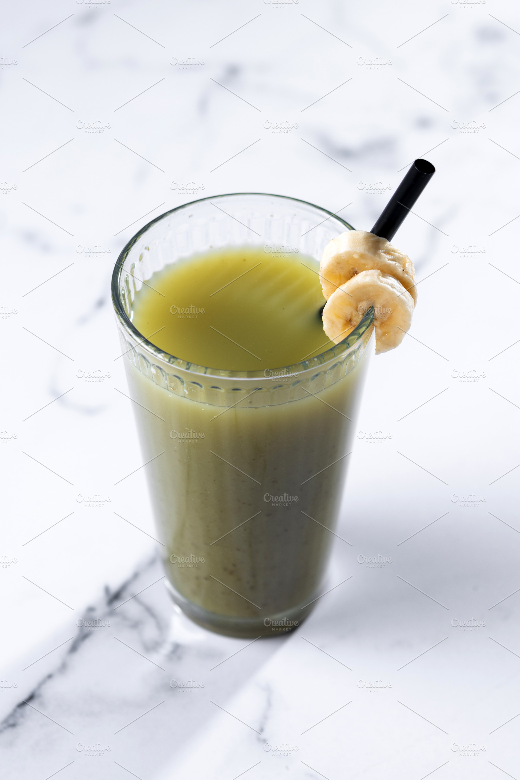 Green smoothie with spinach,banana, apple, and lemon on white marble, a Food & Drink Photo by etorres69