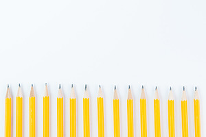 Yellow school pencils containing back to school, copy space, and white, a School & Education Photo by Siân C Photography