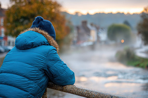 Contemplative moment by the river at sunrise, a Person Photo by AlyaAnd