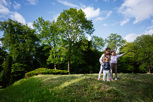 Children playing outdoors in a vibrant green park with blue skies above, a Person Photo by AS photostudio