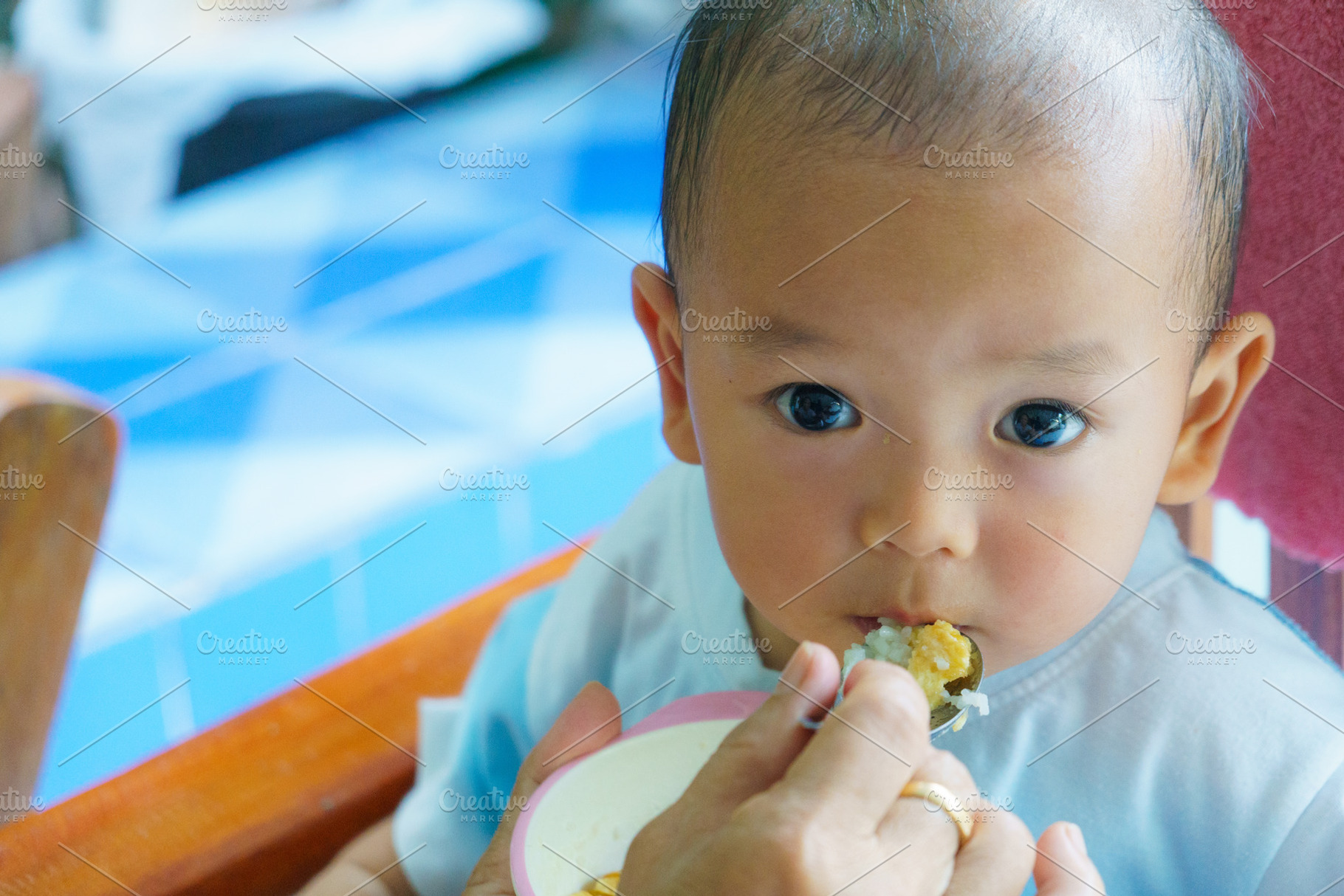 toddler enjoying meal, with curious eyes and joyful expression, a Person Photo by a454