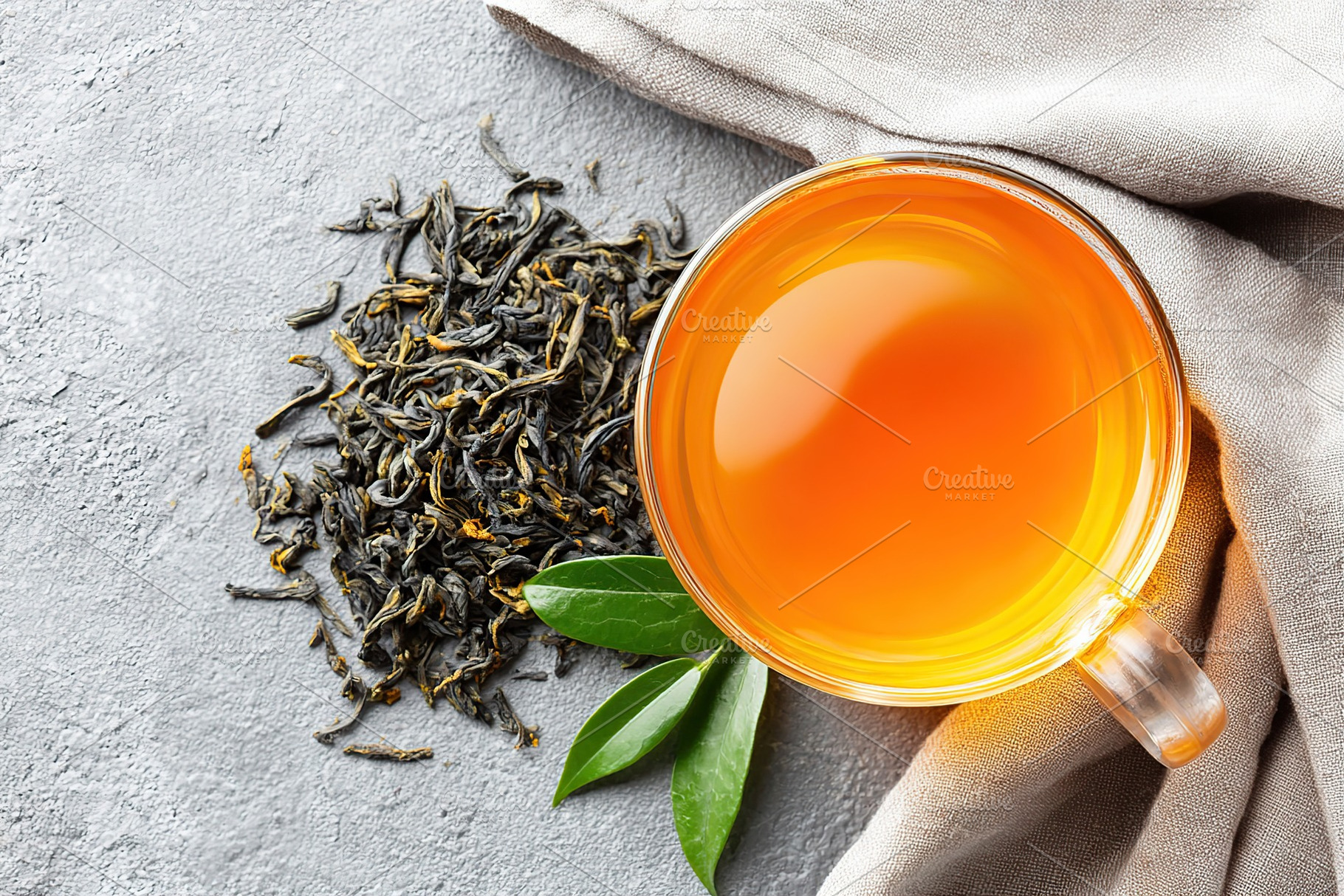 Steeping tea leaves in a glass cup for a warm, refreshing beverage experience, a Food & Drink Photo by AlyaAnd