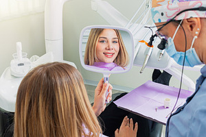 Young woman admiring her smile after dental procedure, a Health & Medical Photo by Antonio Gravante Market