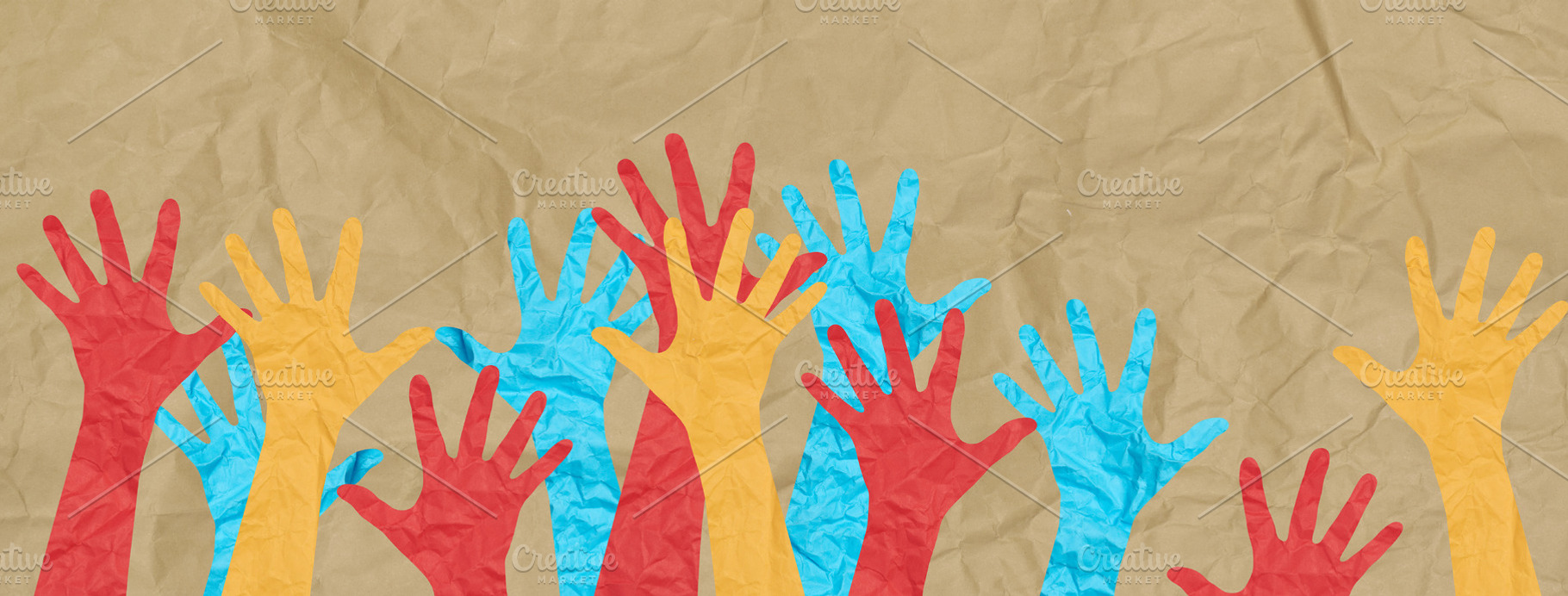 Multicolored paper hands raised against a background of crumpled, an Abstract Photo by ndanko