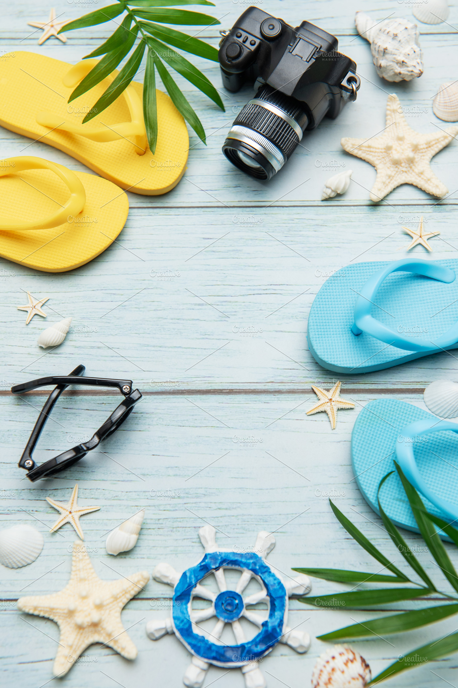 Summer accessories arranged on blue wooden planks create the per, a Holiday Photo by Olena Rudo