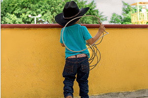 young mexican cowboy with lasso