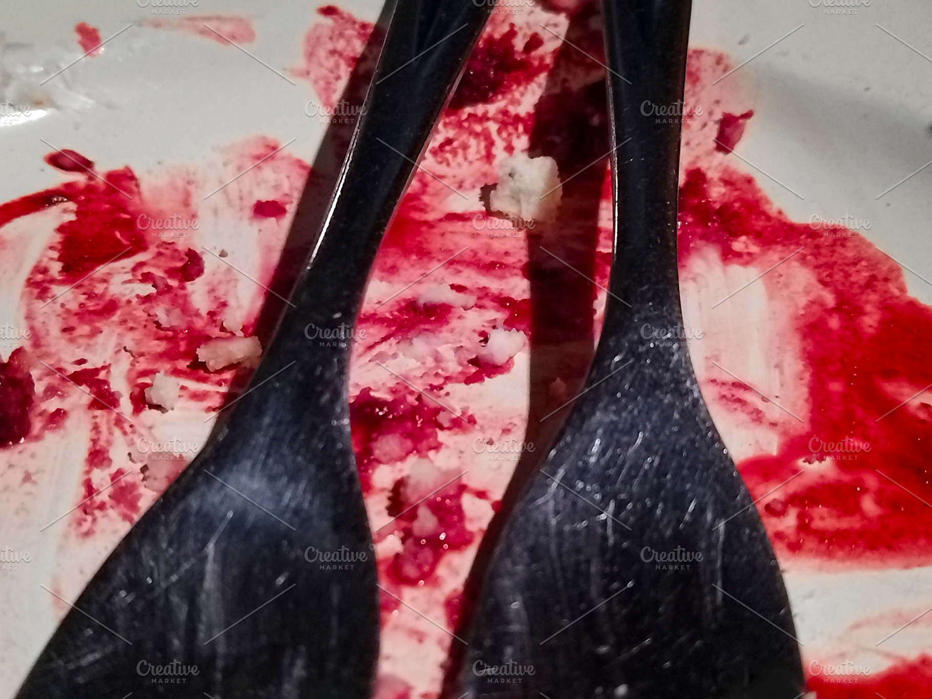 Close-up of black forks on red-smeared plate, a Food & Drink Photo by DanFLCreativo