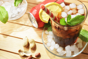 Cola soda on wooden table with appetizers on sunny day, a Food & Drink Photo by Davizro's Market