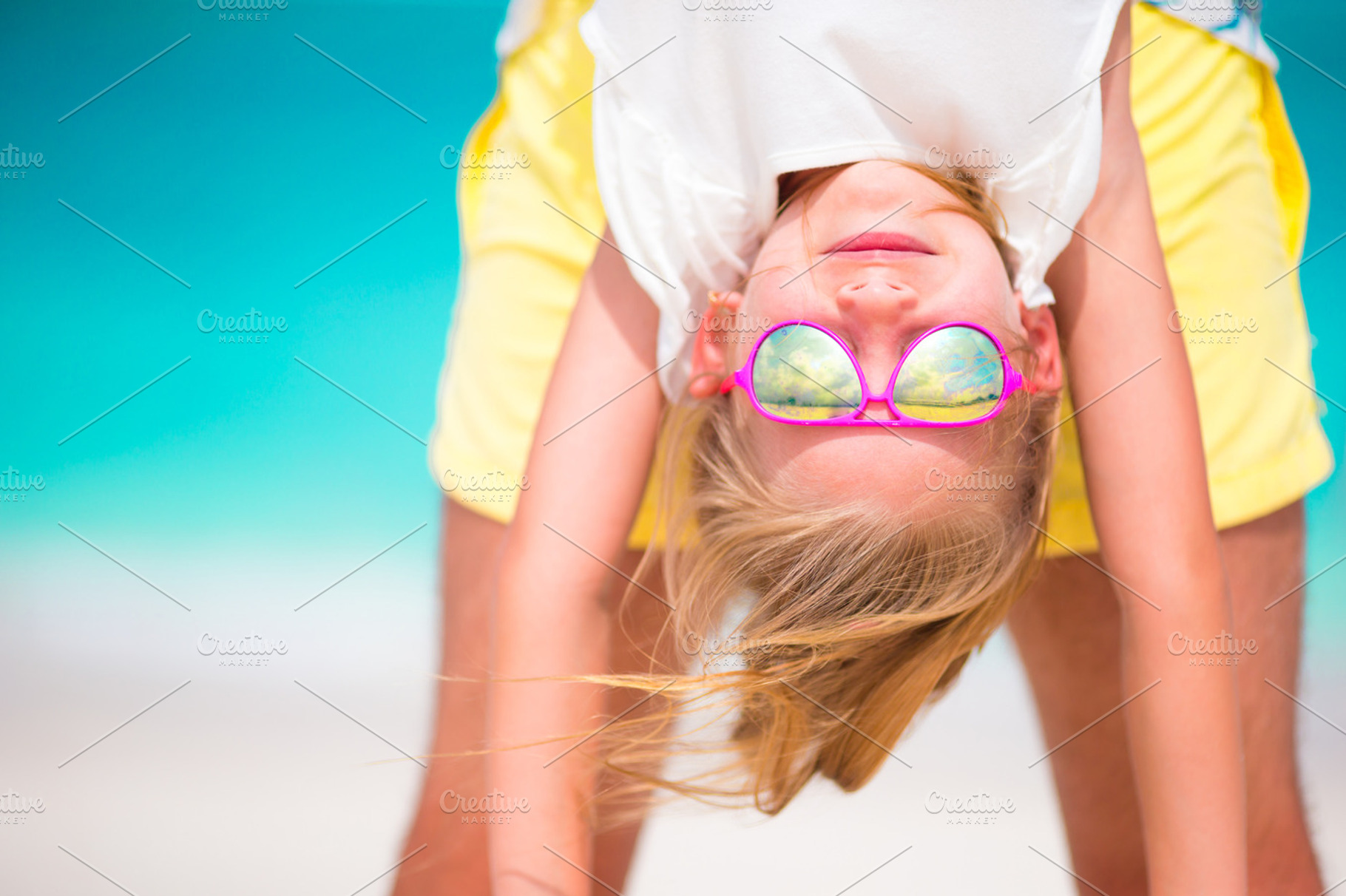 Little girl and her dad enjoy summer vacation at perfect beach, a Person Photo by travnikovstudio