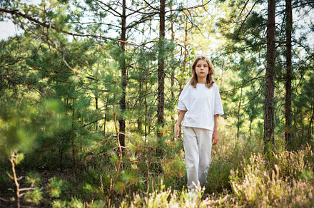 A child exploring a serene forest trail on a sunny day, surround, a Person Photo by Olena Rudo