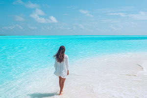 Woman walking on a tropical sandbar, a Nature Photo by AlyaAnd