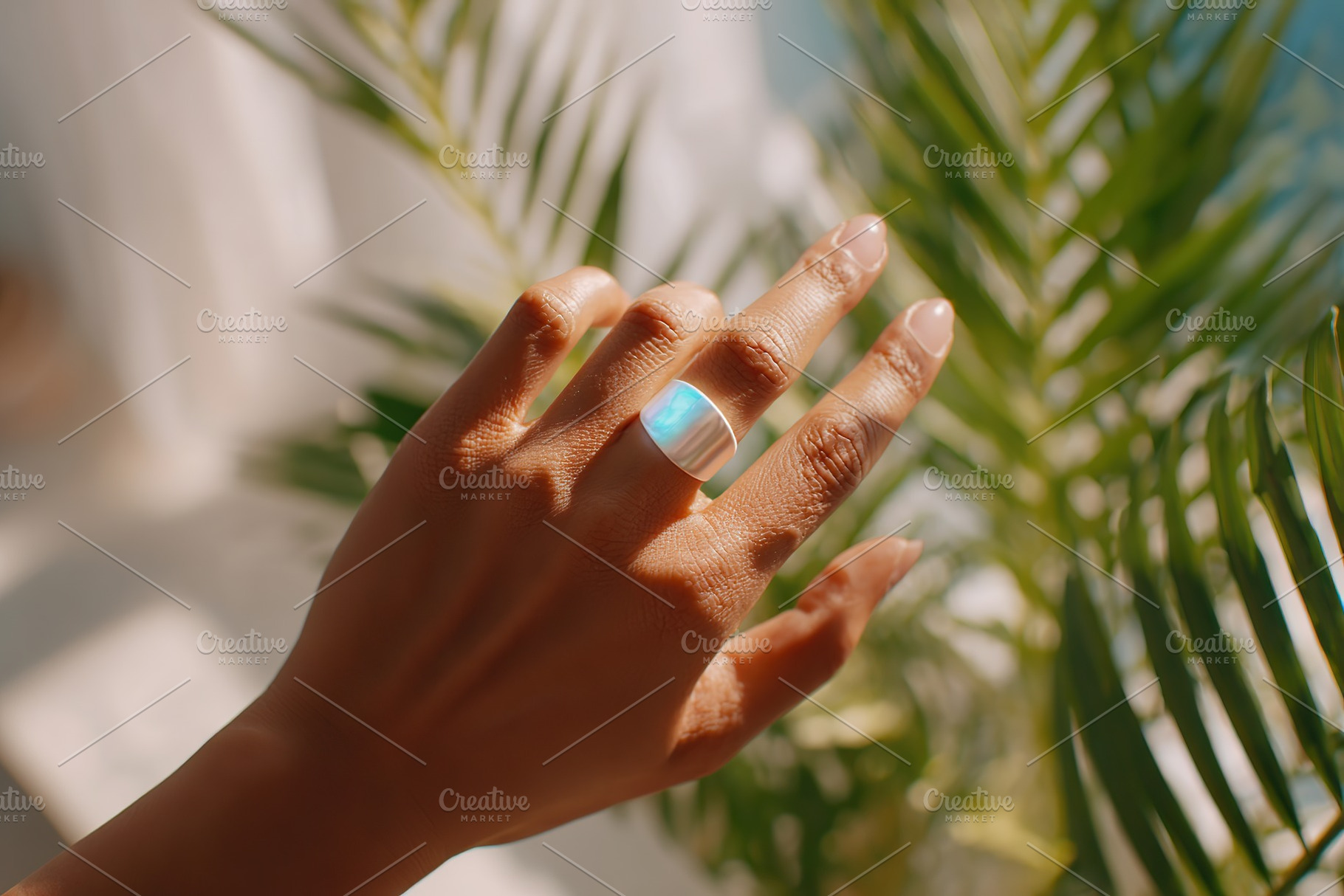 Smart ring mockup showcasing design on hand reaching toward sunlight with tropi, a Photo by AlyaAnd