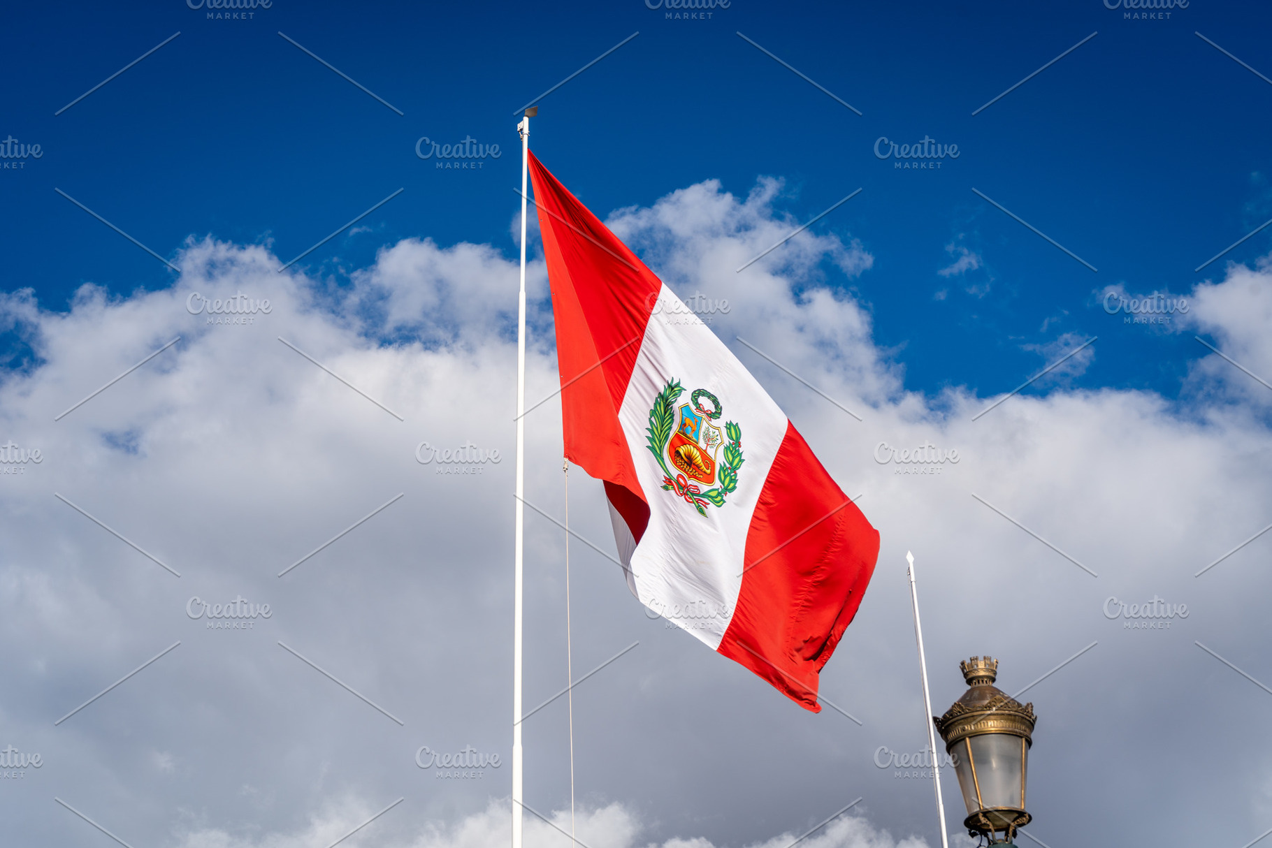 Peruvian National Flag Waving Against a Bright Blue Sky, a Background Photo by GoodGoods