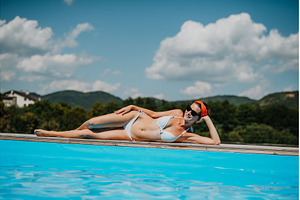 Young woman lying by the on edge of