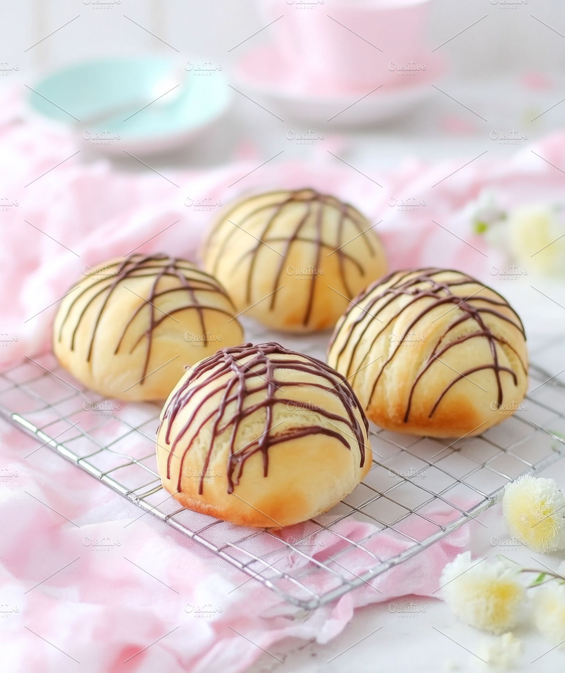 Easter chocolate drizzled sweet buns on cooling rack with soft p, a Photo by Dvoevnore photos