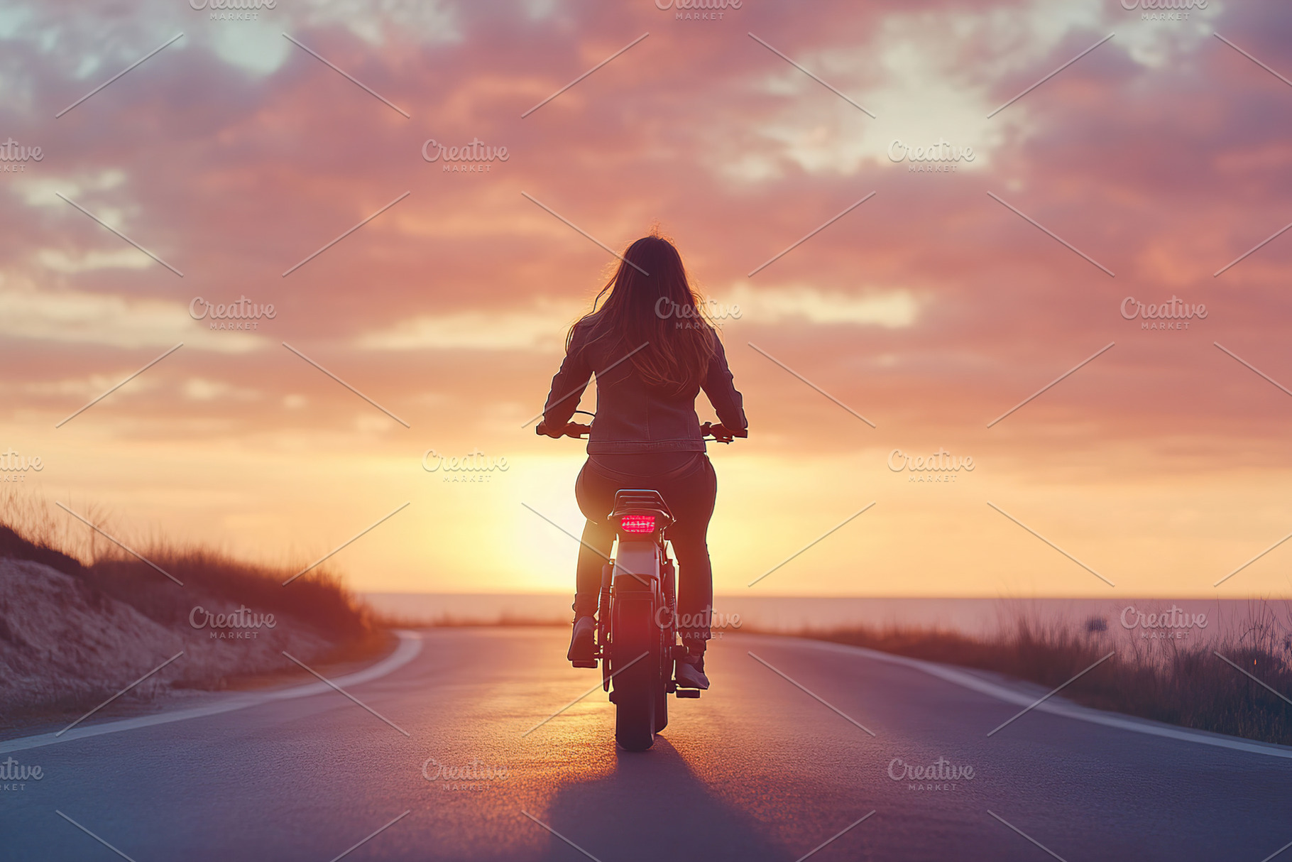 Woman rides electric bike along scenic coastal road at sunset, a Sports & Recreation Photo by AlyaAnd