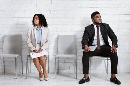 Black man and woman looking in opposite directions, feeling competitive while w, a Photo by Prostock-Studio