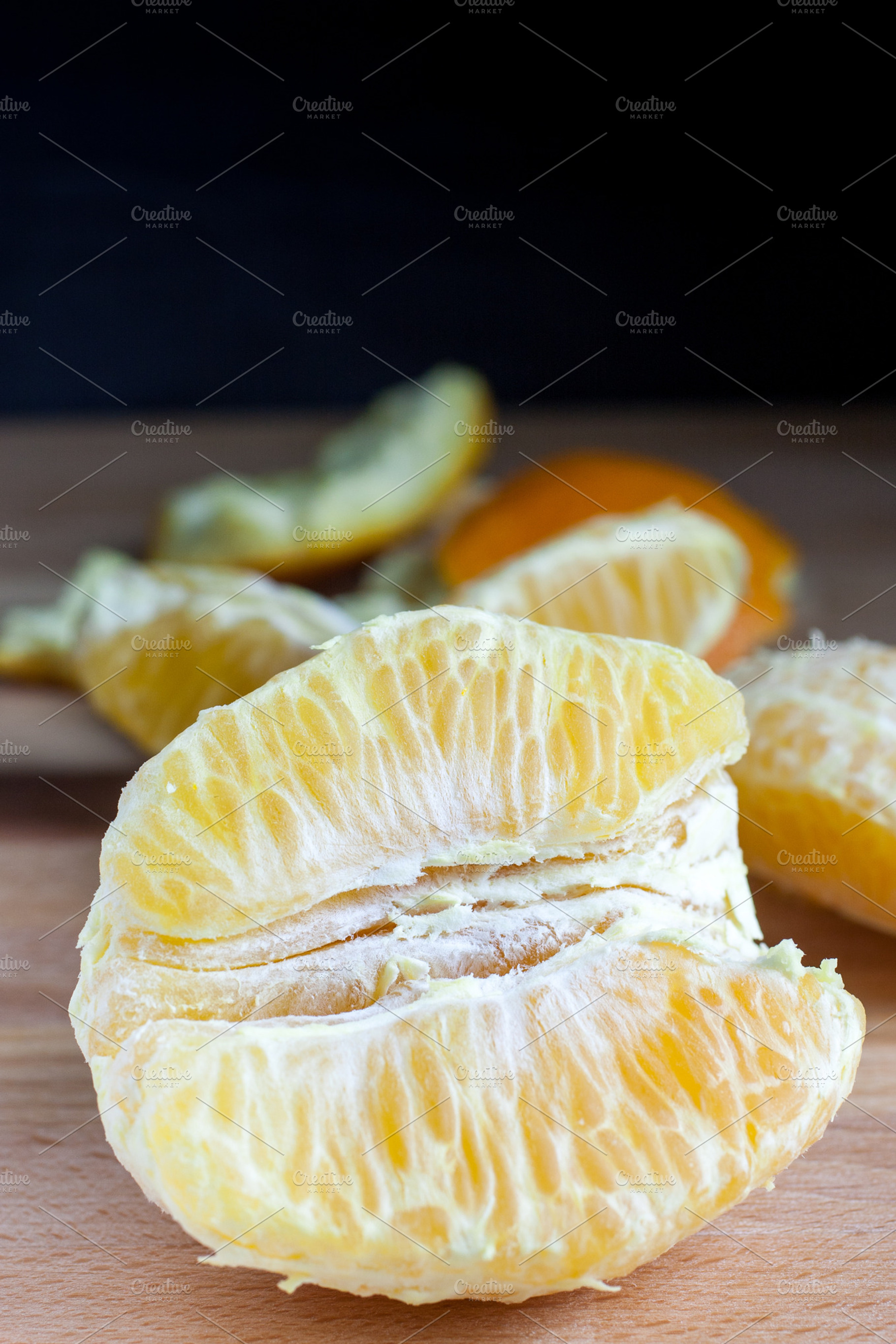 Fresh peeled oranges stock photo containing citrus and cutting board, a Food & Drink Photo by Southern Light