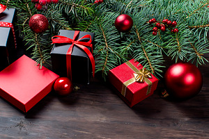 Black and red christmas gift box with red ribbon and fir bran