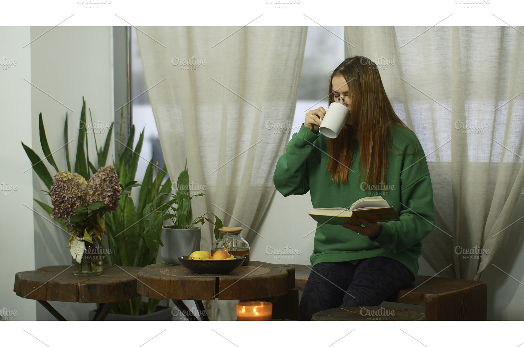Young woman with glasses is reading, a Person Photo by Media Whale Stock
