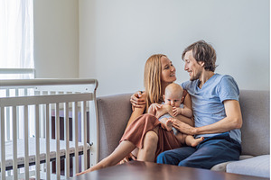 Mother and father sitting on sofa