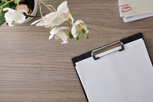 Clipboard and Orchid on Wooden Desk, a Business Photo by Davizro's Market