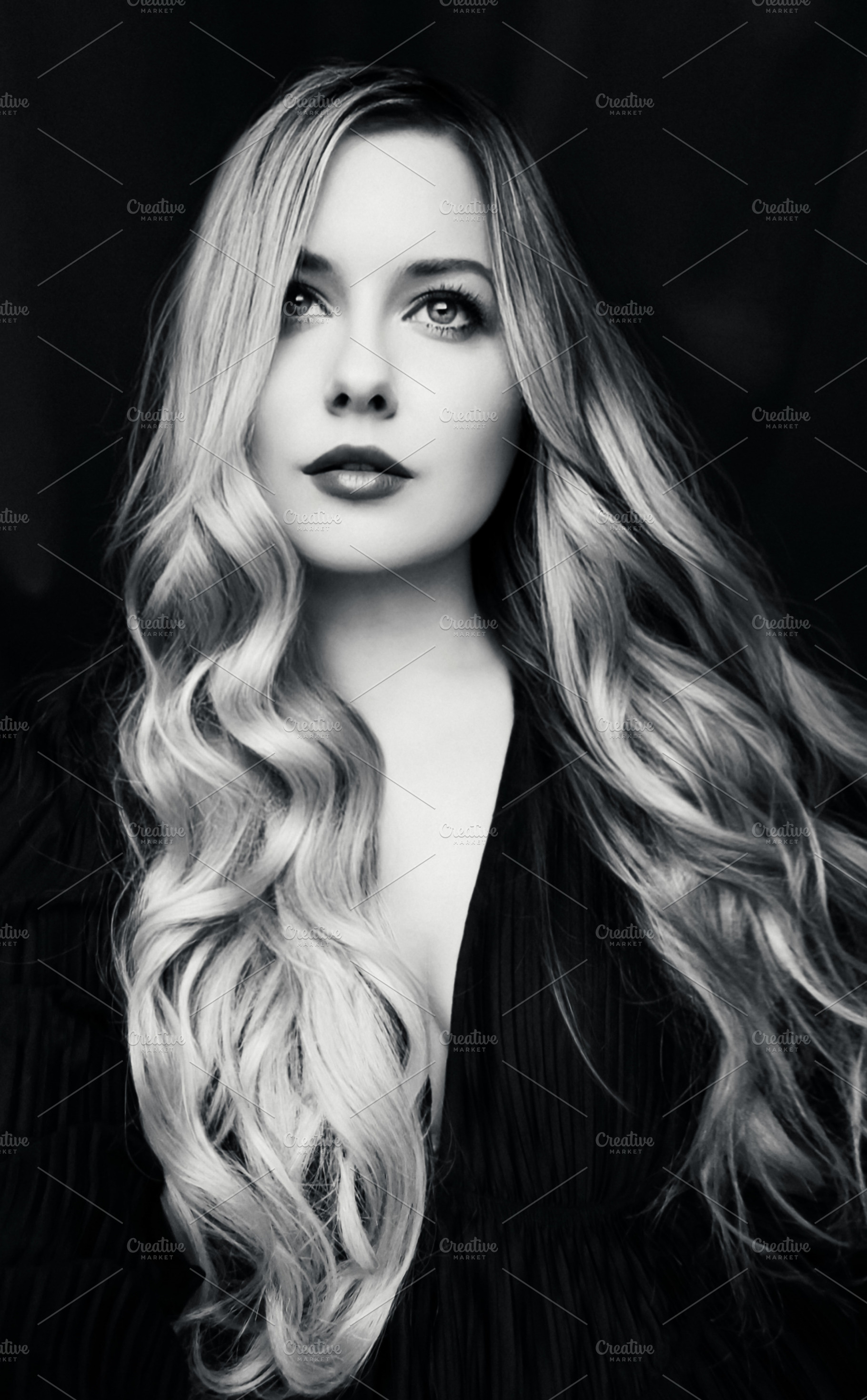 Young woman with long wavy blonde hair looking up, concept of in, a Person Photo by Studio ANNA