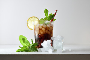 Refreshing cola drink with ice on a white isolated background, a Food & Drink Photo by Davizro's Market