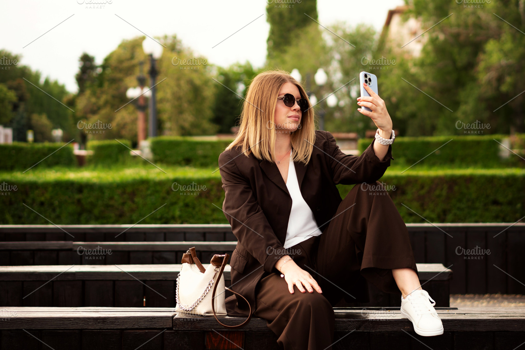 Young woman sitting outdoors, a Person Photo by Elena Vagengeim